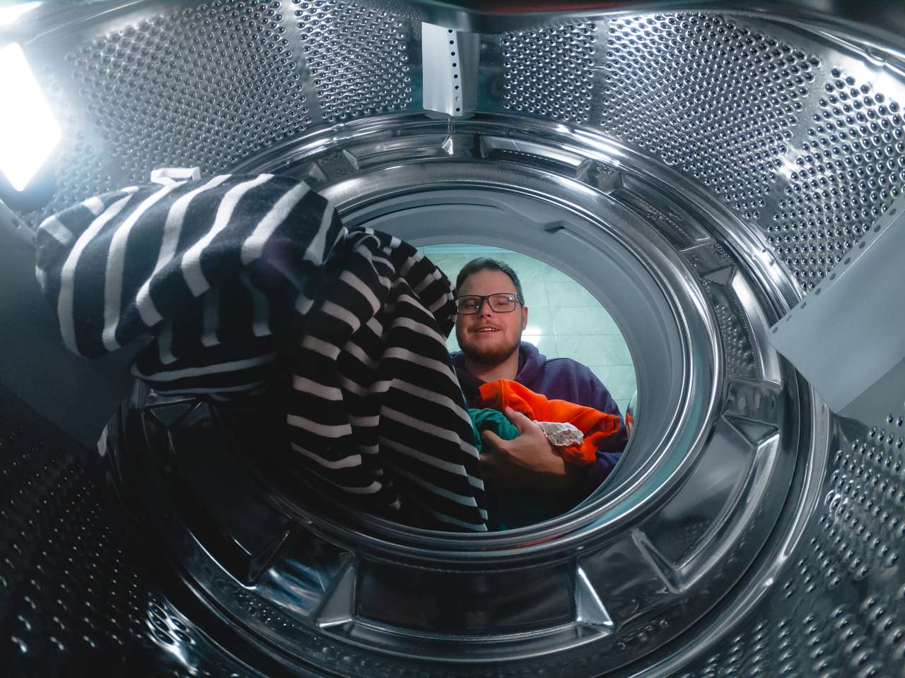 washing-machine-is-loaded-with-dirty-clothes-by-a GE washer repair services
